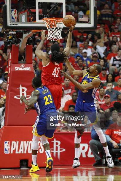 Nene Hilario of the Houston Rockets goes up for a shot defended by Kevin Durant of the Golden State Warriors and Draymond Green in the third quarter...