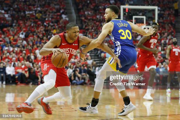 Eric Gordon of the Houston Rockets drives to the basket defended by Stephen Curry of the Golden State Warriors in the second quarter during Game...