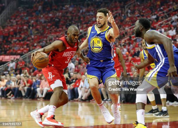Chris Paul of the Houston Rockets drives to the basket defended by Klay Thompson of the Golden State Warriors in the first quarter during Game Three...