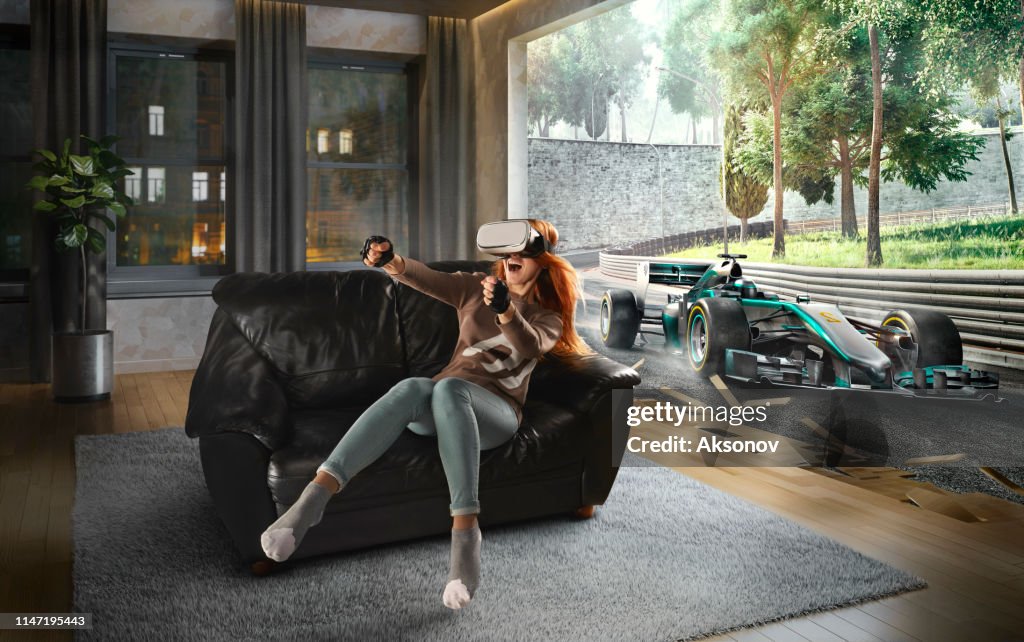 Woman in VR Glasses. Virtual Reality with racing cars on the track