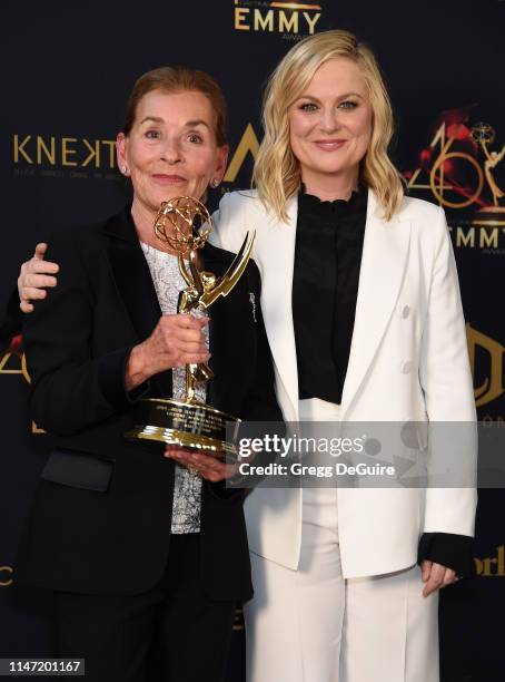 Judge Judy poses with the Lifetime Achievement Award in the press room with Amy Poehler during the 46th annual Daytime Emmy Awards at Pasadena Civic...