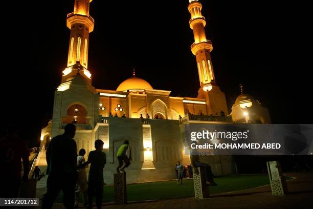 Palestinian Muslim worshippers arrive to pray at a mosque on the occasion of Laylat al-Qadr, also known as the Night of Power, in Gaza City on May 31...