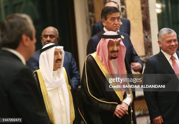 Saudi Arabia's King Salman bin Abdulaziz stands next to his Jordanian counterpart, King Abdullah II of Jordan, and Kuwait's Emir Sheikh Jaber...