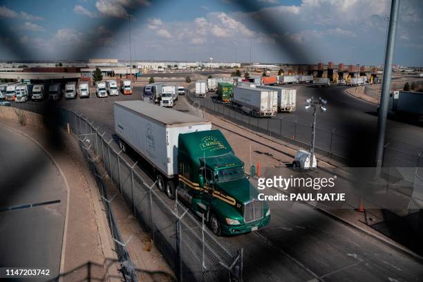 Semi-trucks cross the border at the Zaragoza International Bridge, in Juarez, Mexico, across the border from El Paso, Texas on May 31, 2019. -...