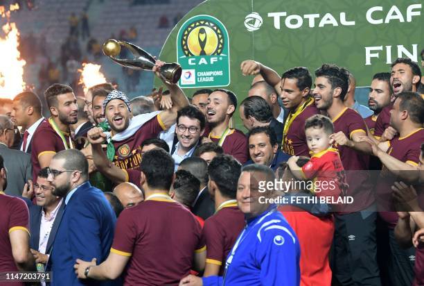Esperance de Tunis players hold hold up the trophy after winning during the 2nd leg of CAF champion league final 2019 football match between...