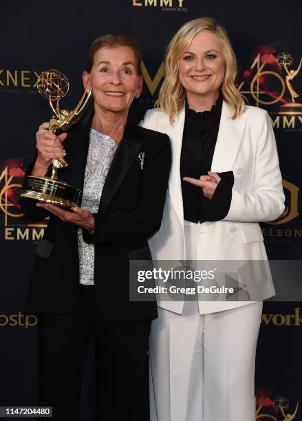 Judge Judy poses with the Lifetime Achievement Award in the press room with Amy Poehler during the 46th annual Daytime Emmy Awards at Pasadena Civic...