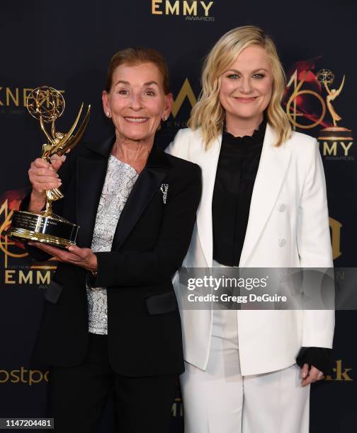 Judge Judy poses with the Lifetime Achievement Award in the press room with Amy Poehler during the 46th annual Daytime Emmy Awards at Pasadena Civic...