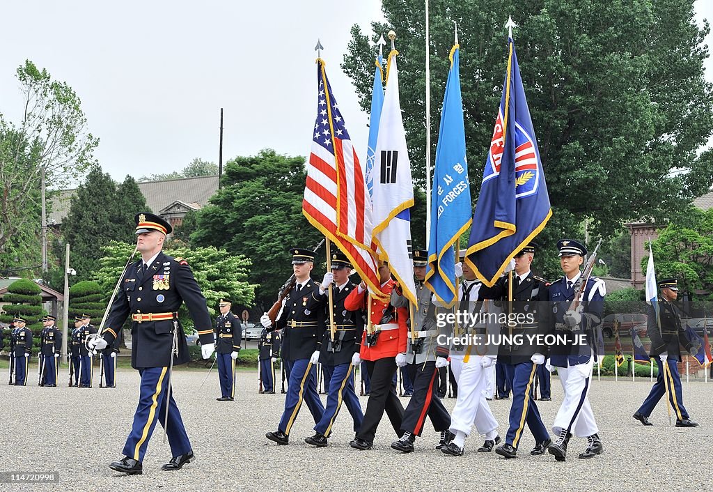 Un Command Base Honour Guards of the United Nations Command march with flags during a ...