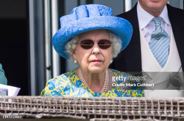 Queen Elizabeth II watches the racing from the royal balcony at the Epsom Derby at Epsom Racecourse on June 1, 2019 in Epsom, England.
