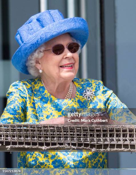 Queen Elizabeth II watches the racing from the royal balcony at the Epsom Derby at Epsom Racecourse on June 1, 2019 in Epsom, England.
