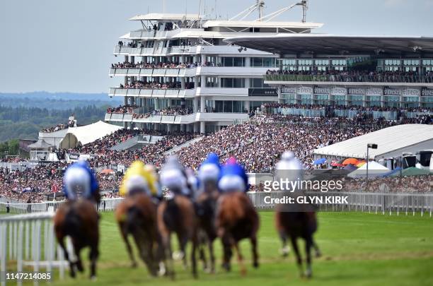 Viewed from the top of the course, runners and riders take the corner into the straight during the first race, on the second day of the Epsom Derby...