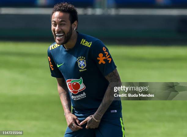 Neymar Jr smiles during a training session of the Brazilian national football team at the squad's Granja Comary training complex on June 01, 2019 in...