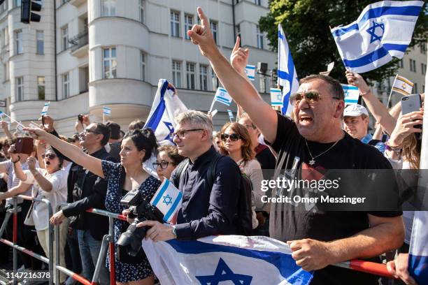 Counter demonstrators wave Israeli flags as the annual Al-Quds march pass by on June 1, 2019 in Berlin, Germany. Critics accuse the Al-Quds marchers...