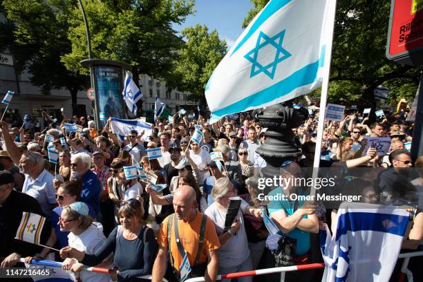 Counter demonstrators wave Israeli flags as the annual Al-Quds march pass by on June 1, 2019 in Berlin, Germany. Critics accuse the Al-Quds marchers...