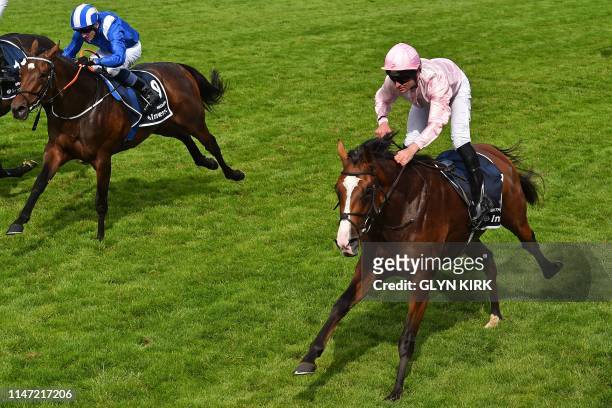 Jockey Seamie Heffernan slows after riding Anthony Van Dyck to victory, jockey Chris Hayes on Madhmoon second, in the Derby Stakes on the second day...