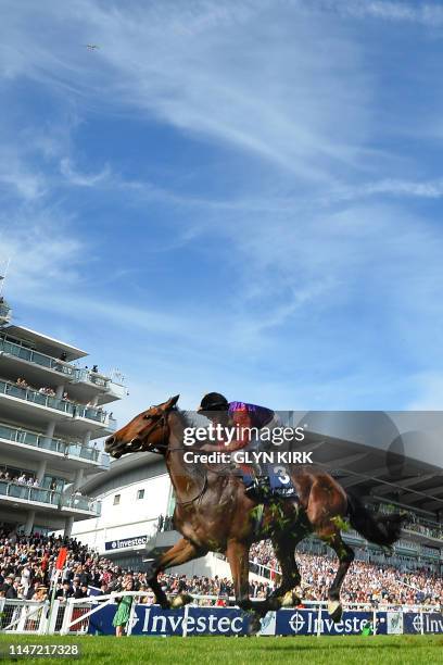 The Queen's runner, Sextant, ridden by jockey Ryan Moore passes the stands after coming fourth in the Out of The Ordinary handicap on the second day...