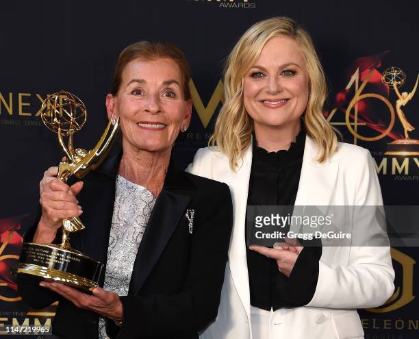 Judge Judy poses with the Lifetime Achievement Award in the press room with Amy Poehler during the 46th annual Daytime Emmy Awards at Pasadena Civic...