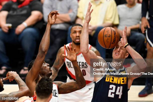 Mason Plumlee of the Denver Nuggets wears a ball to the face after it was hit by Al-Farouq Aminu of the Portland Trail Blazers during the third...