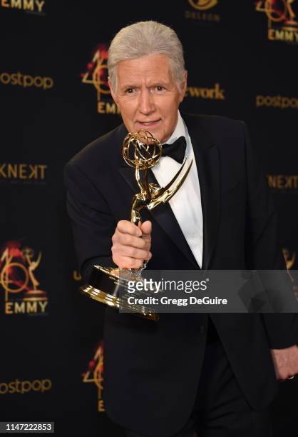 Alex Trebek poses with the Daytime Emmy Award for Outstanding Game Show Host in the press room during the 46th annual Daytime Emmy Awards at Pasadena...