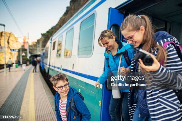 family getting out of train at the manarola train station, cinque terre - train leaving stock pictures, royalty-free photos & images