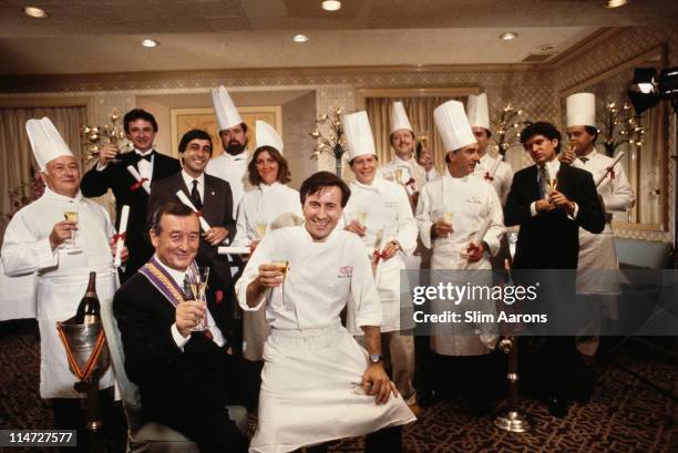 Italian-born restaurateur Sirio Maccioni with staff at Le Cirque, his establishment in New York, circa 1990. Executive Chef Daniel Boulud is seated,...