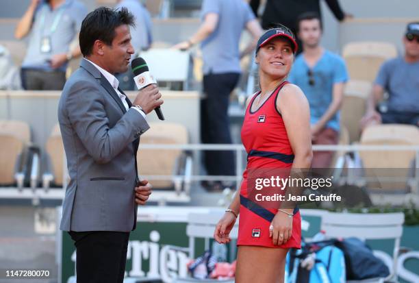 Sofia Kenin of the United States looks at her entourage while being interviewed on court by Fabrice Santoro following her third round victory against...