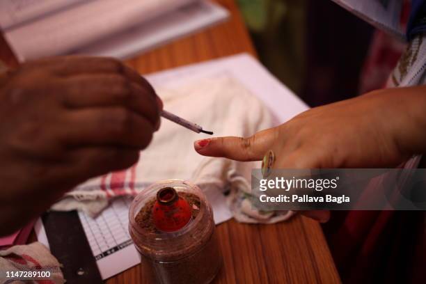 Indelible India ink being put on the finger of a voter. Elections for India's Parliament kicked off today with about 900 million voters being...