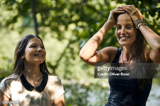 portrait of happy mother and daughter with wet hair outdoors in summer - women in wet tee shirts stock pictures, royalty-free photos & images