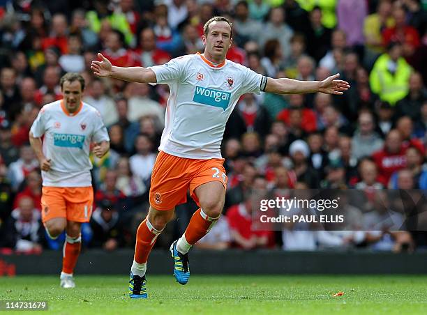 Blackpool's Scottish midfielder Charlie Adam celebrates after scoring during the English Premier League football match between Manchester United and...