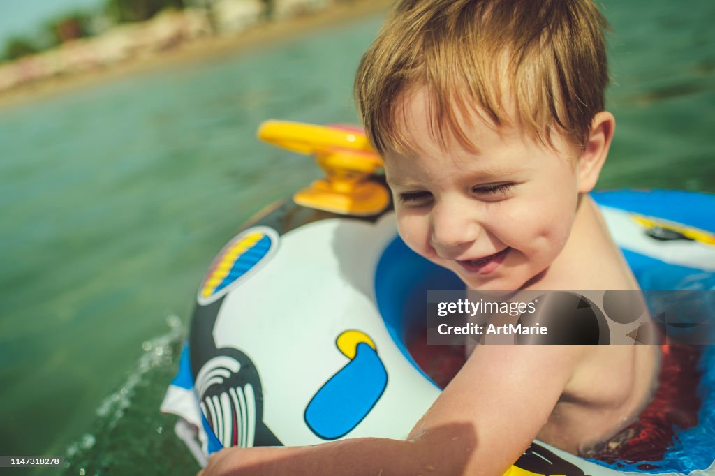 Child Inflatable Raft Cute Child In Inflatable Raft In The Sea On Beach Holidays High-Res ...