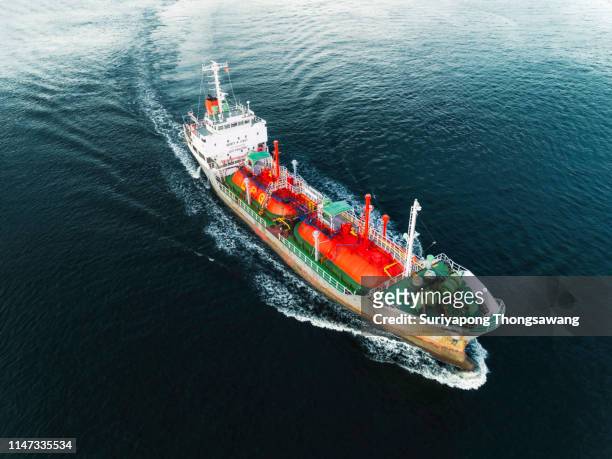 aerial view ship tanker liquefied petroleum gas (lpg) on the sea with beautiful wave pattern delivery  from refinery for transportation. - fuel storage tank stock-fotos und bilder