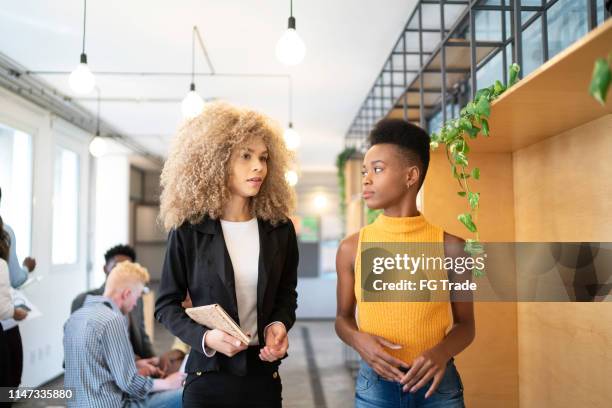 two businesswoman walking at modern office - employee leaving stock pictures, royalty-free photos & images