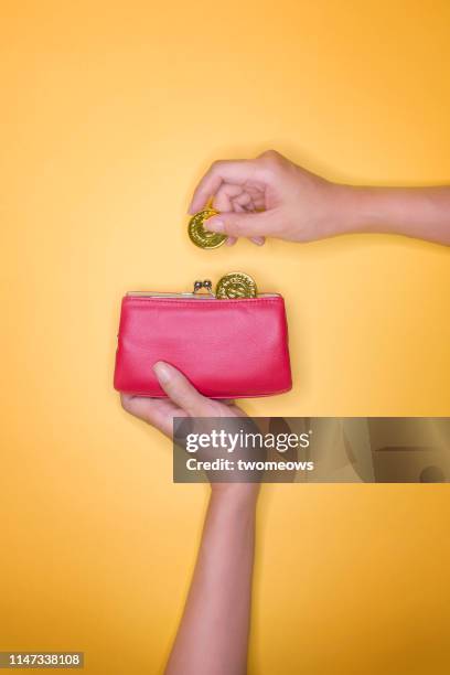 saving or spending money concept image. - metallic purse stock pictures, royalty-free photos & images