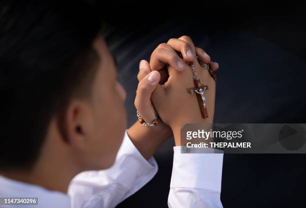 boy hands first communion - rosary beads stock pictures, royalty-free photos & images