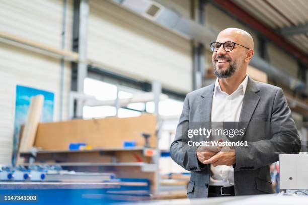 happy businessman in factory - one man only stock pictures, royalty-free photos & images