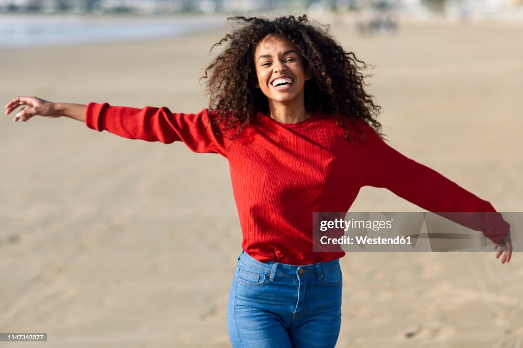 Portrait of laughing young woman on the beach