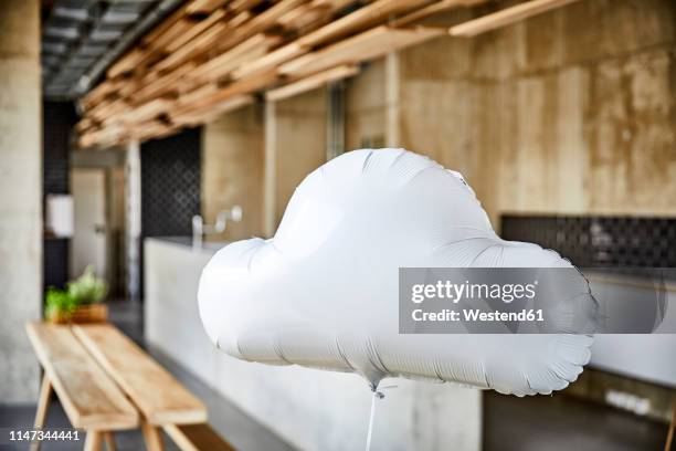 cloud balloon floating in creative office - büro und wolke stock-fotos und bilder