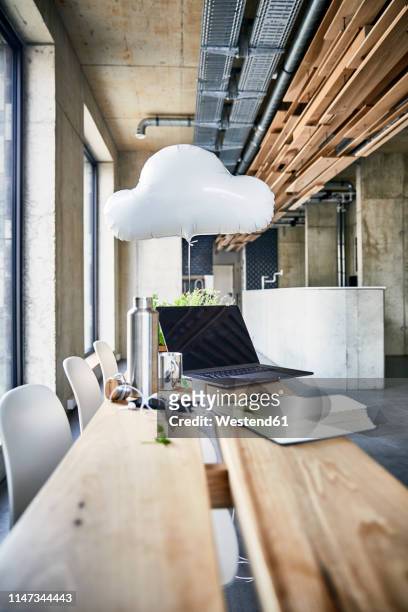 creative office with cloud balloon and laptop - büro und wolke stock-fotos und bilder