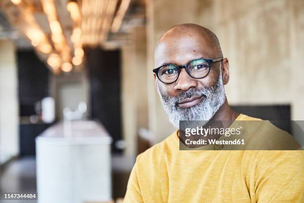 portrait of confident mature businessman in office - casual professional man stockfoto's en -beelden