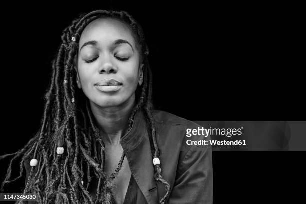 portrait of woman with dreadlocks in front of black background - black and white stock pictures, royalty-free photos & images