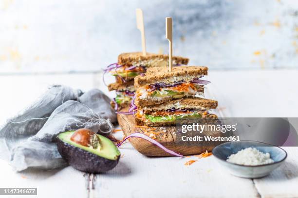 veggie sandwich, whole meal toast bread with grated carrot, red cabbage, white cabbage, avocado and cheese - tea towels stock pictures, royalty-free photos & images