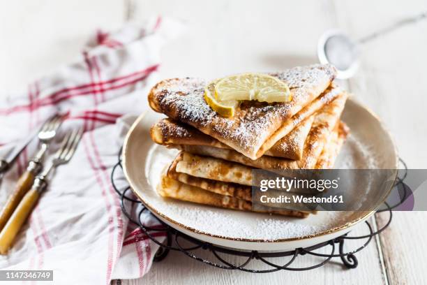 crepes with icing sugar and lemon - pancakes on a plate stock pictures, royalty-free photos & images
