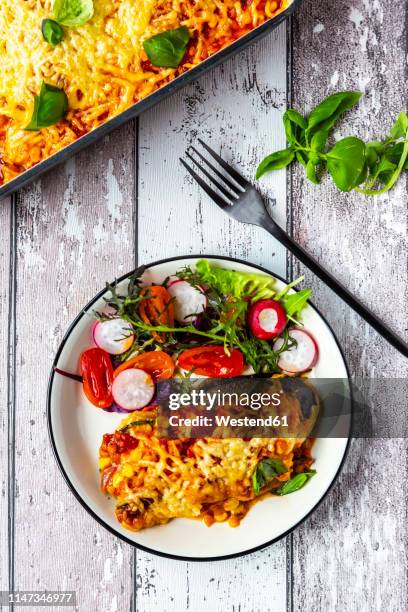 aubergine lasagne on a plate with mixed salad - parmesan cheese overhead stock pictures, royalty-free photos & images