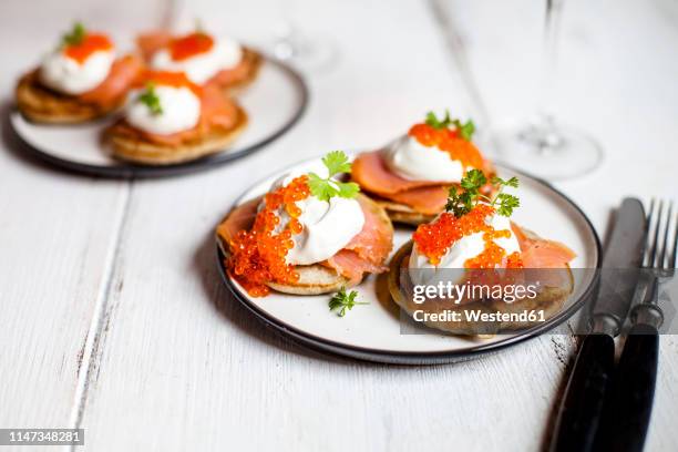 russian style blini with salmon, sour cream and trout roe - 魚卵 ストックフォトと画像