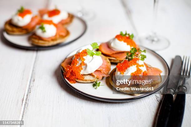russian style blini with salmon, sour cream and trout roe - fish roe stock pictures, royalty-free photos & images
