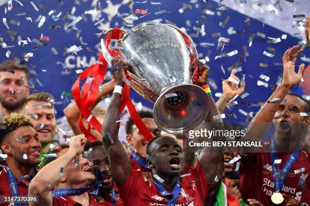Liverpool's Senegalese striker Sadio Mane raises the trophy after winning the UEFA Champions League final football match between Liverpool and...