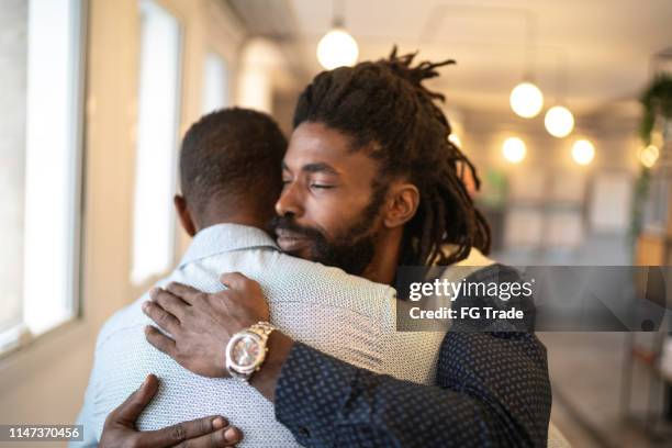 homme d’affaires embrassant célébrant de bonnes nouvelles - rasta man photos et images de collection