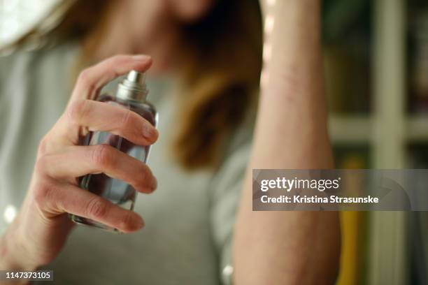 woman spraying perfume - perfume sprayer bildbanksfoton och bilder