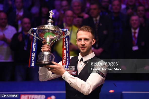 Judd Trump celebrates as he wins the 2019 Betfred World Snooker Championship final between John Higgins and Judd Trump at Crucible Theatre on May 06,...