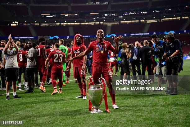 Liverpool's English striker Daniel Sturridge celebrates with the trophy after winning the UEFA Champions League final football match between...